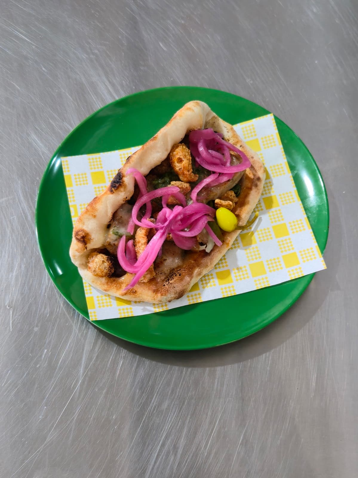 Porky Party Ozzo on a green plate, top-down view