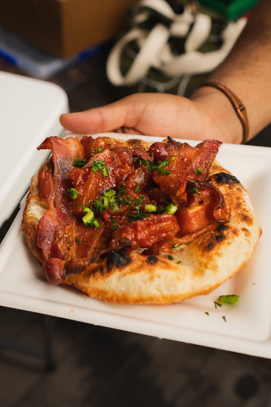 A Bacon & Egg Fritta in close-up — bacon and egg on pan-fried Neapolitan dough