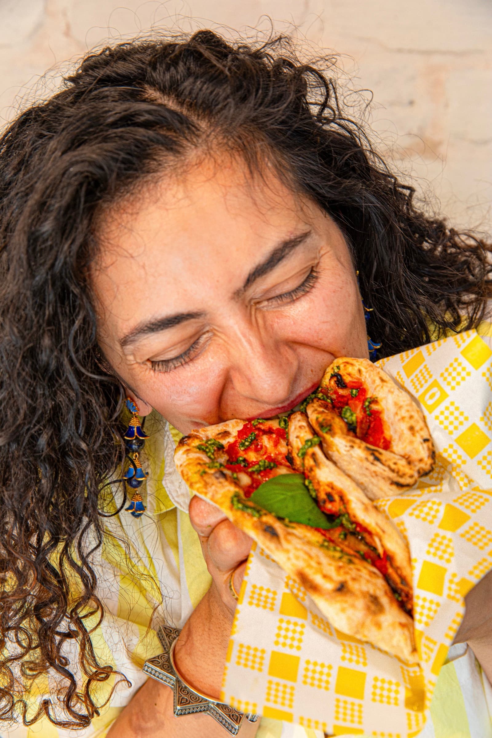 A Margherita Madness pizzino, folded Italian street-style pizza, ready to eat on the harbour walk