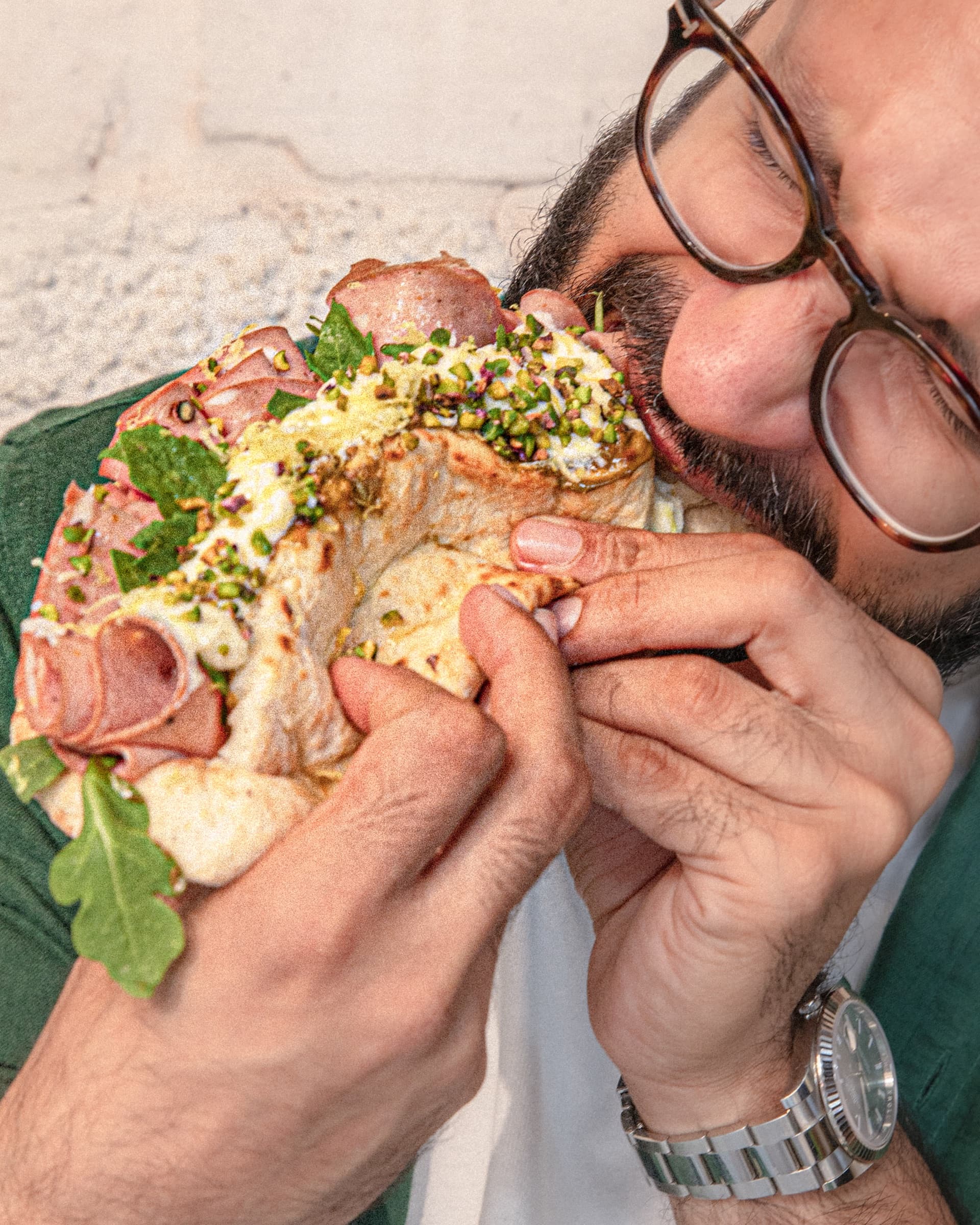 A Mayhem Again ozzo eaten on the harbour walk — pistachio gremolata, mortadella, hot honey, arugula